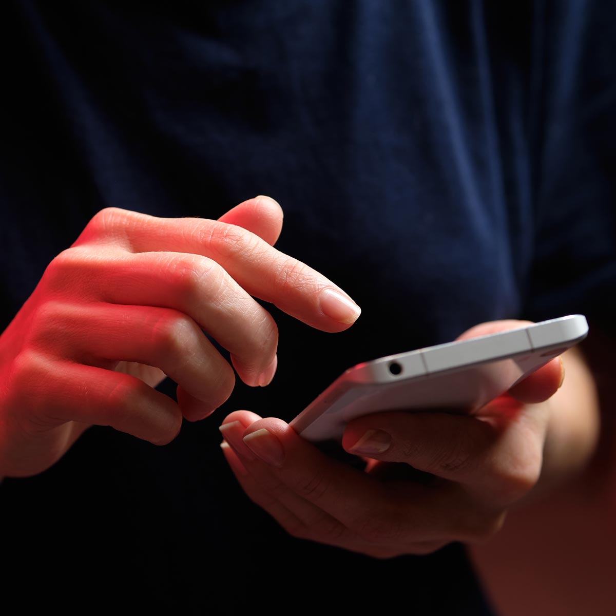 Person holding phone and scrolling through social media Person holding phone and scrolling through social media