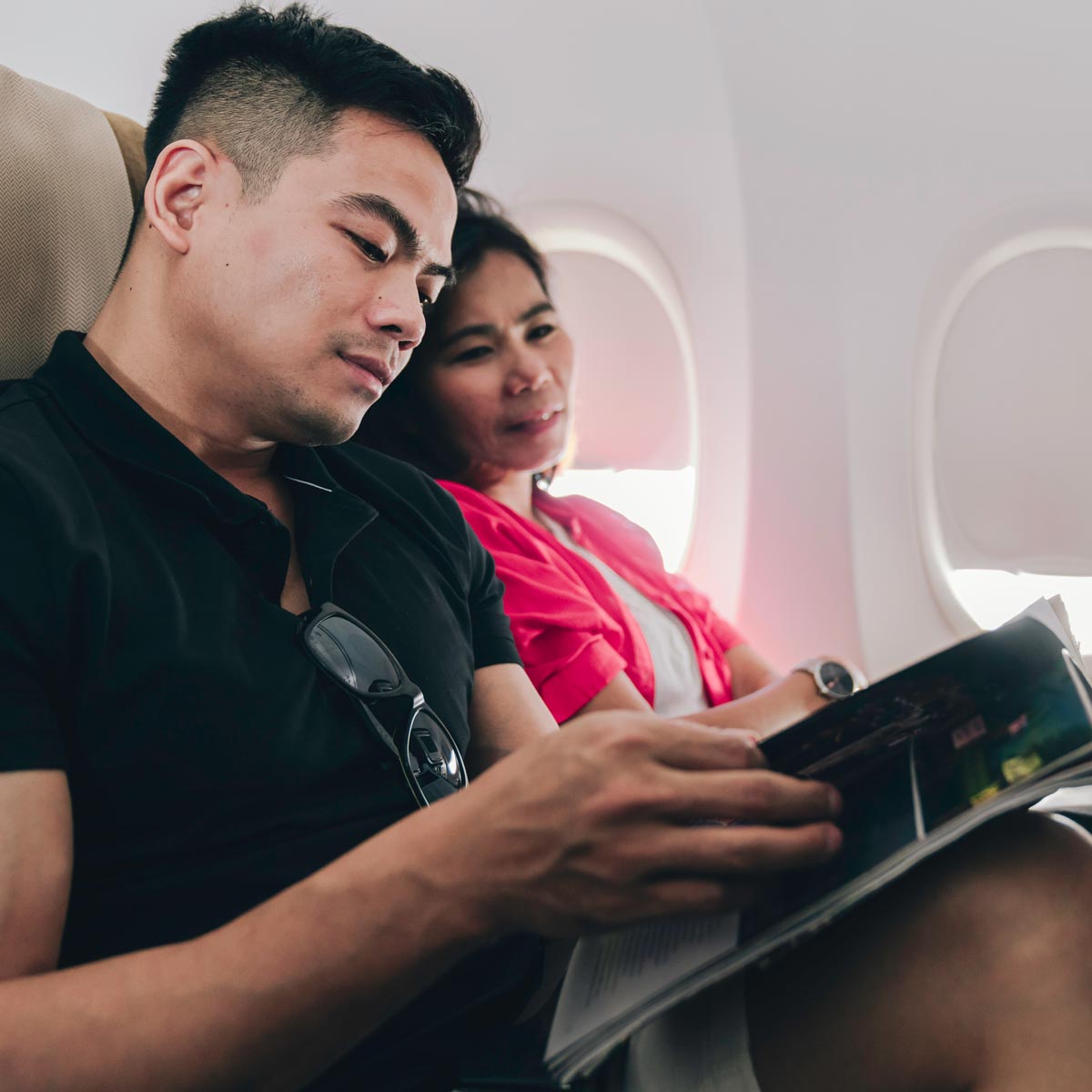 Young couple reading a magazine Young couple reading a magazine
